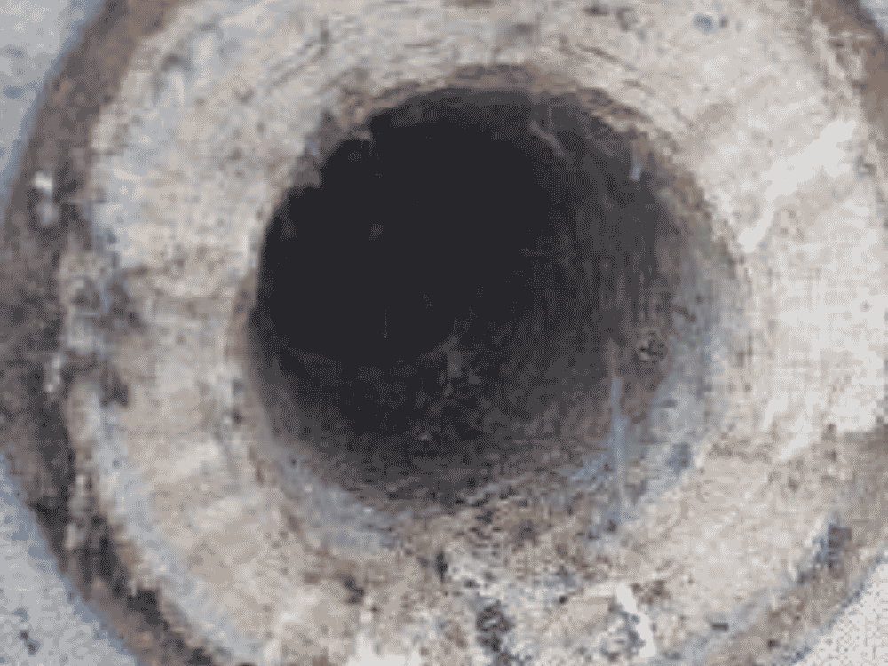 Luton WWTP centrate line before HydroFLOW — hard struvite scale on pipework