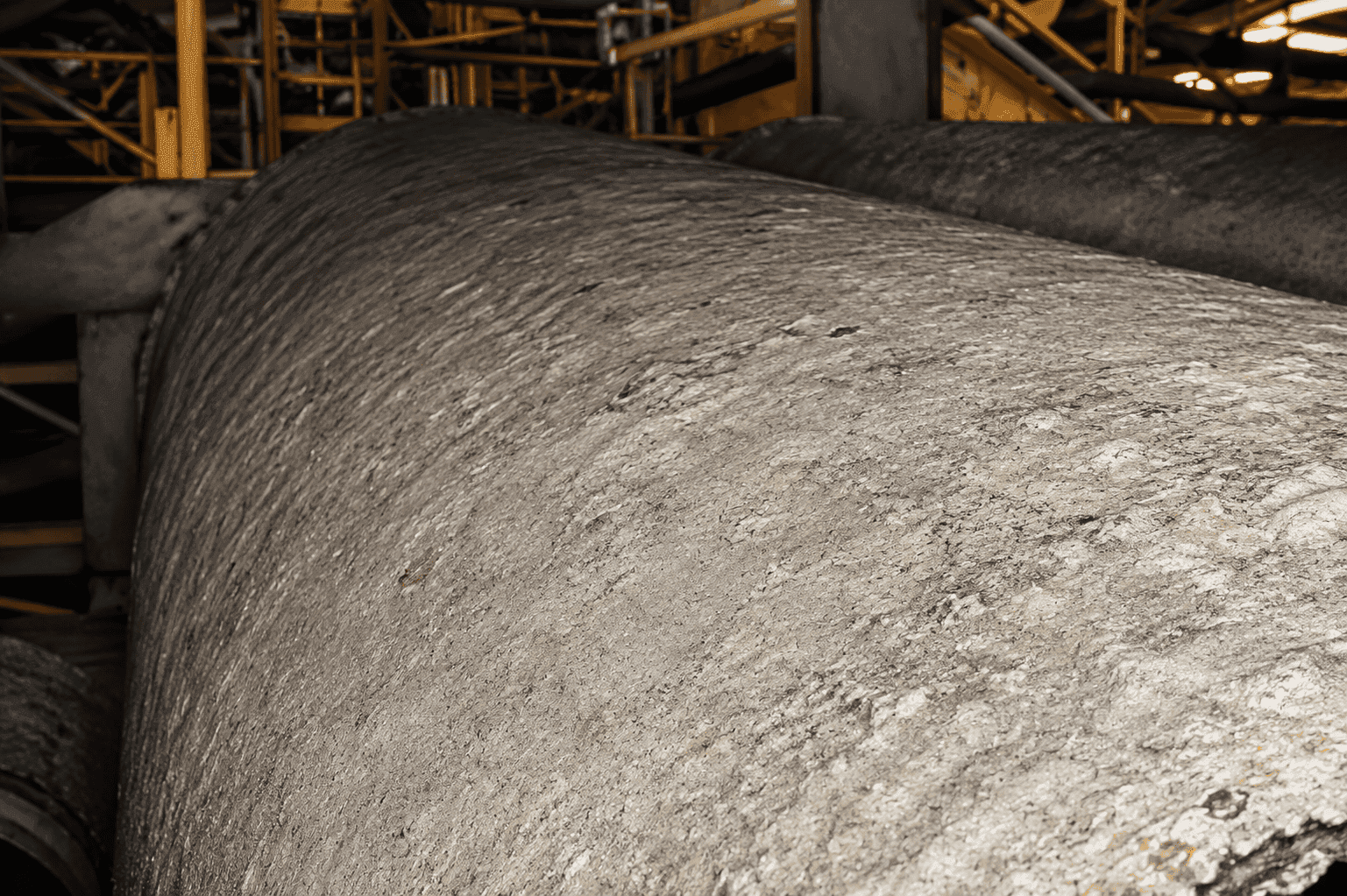 Belt press drum coated in hard struvite scale bridging the drum holes, before HydroFLOW treatment — Water Conserv II Water Reclamation Facility, Orlando, Florida