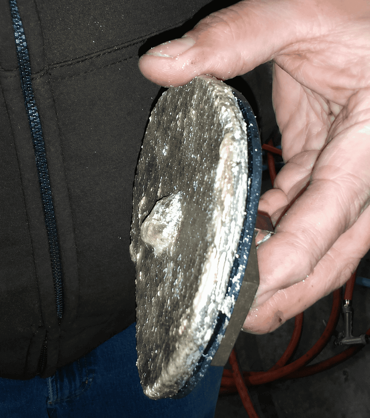 Water heater disc encrusted with a thick crust of limescale before HydroFLOW treatment — apple packing facility, US Northwest