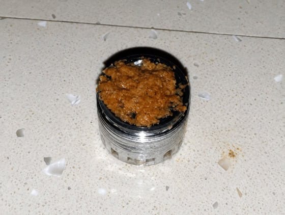 Tap jet breaker completely blocked by orange-brown biofilm before HydroFLOW treatment — Grand Hotel Terme di Comano, Trentino, Italy