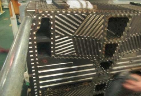 The same fresh water generator plate stack after HydroFLOW, with clean plates and only soft, easily removed scale