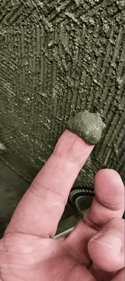 Green biofilm lifted from a seawater plate heat exchanger plate at a pump station in Hong Kong