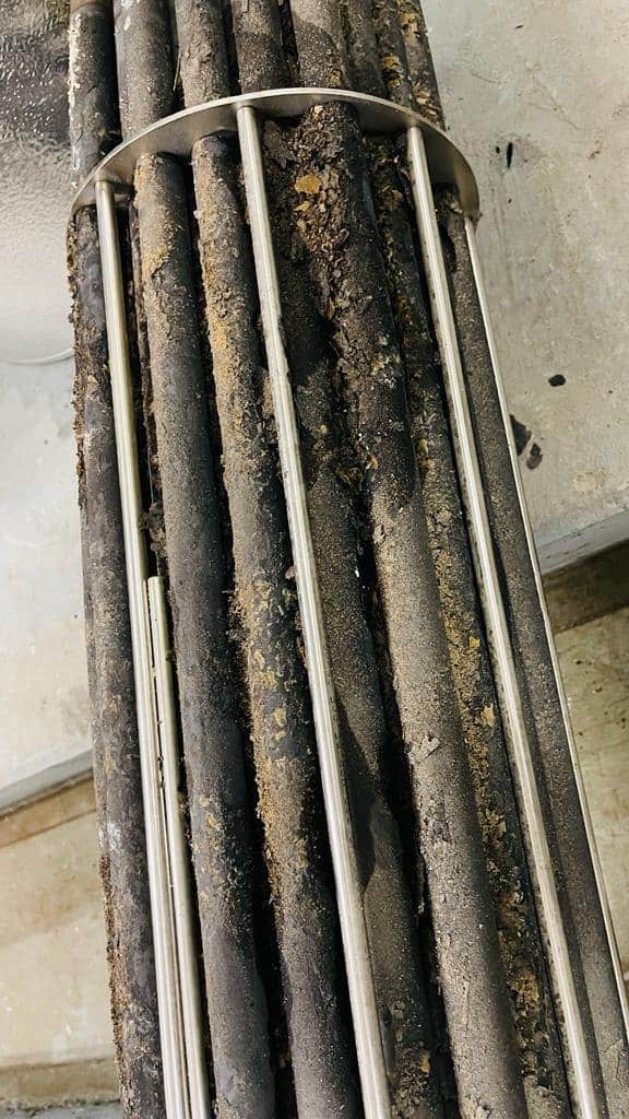 Electric calorifier heating elements at a Macau hotel before HydroFLOW, heavily coated in brown limescale